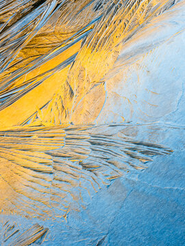 Abstract background. Close up of ice crystals forming patterns on a frozen surface. Winter concept.