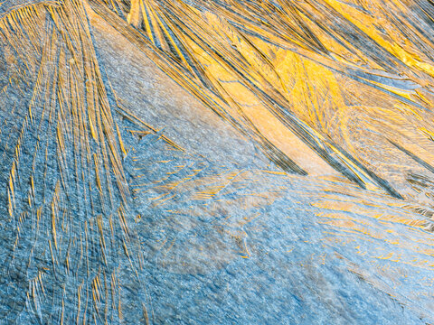 Abstract background of ice crystals forming patterns on a frozen surface, creating a unique texture. Alveo Presena,Trentino,Tonale Pass,Italy.