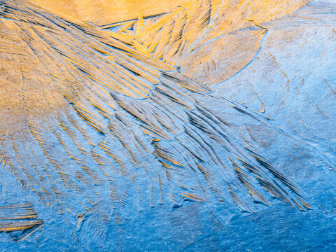 Abstract background. Ice crystals form patterns on a frozen surface, creating a unique texture. Alveo Presena,Trentino,Tonale Pass,Italy.
