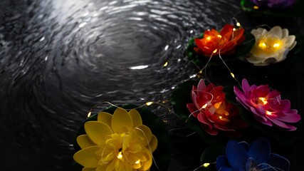 Vesak lantern lotus flowers floating on dark water, Buddha birthday celebration background © Mantas Žiličius