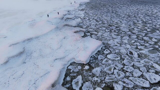 Aerial view of the frozen Baltic sea shows a contrast between the solid ice and the fragmented ice floes, Mikoszewo, pomorskie, Poland.