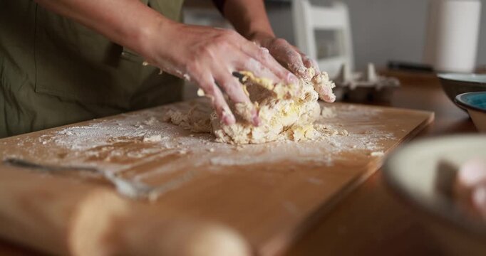 Woman preparing dough for handmade tagliatelle pasta indoor - Italian food, culture and lifestyle concept