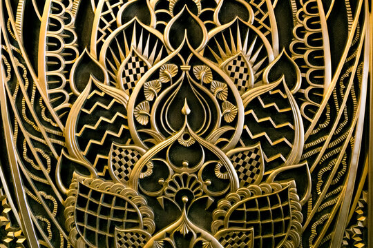 Gold ornamental Art Deco lattice pattern on black background