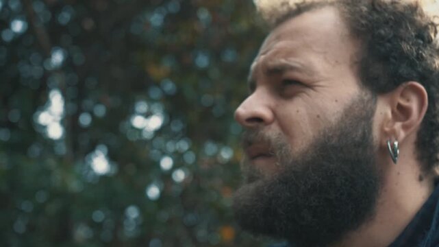 Young brown haired man singing sadly remembering a song shared with his ex girlfriend. Emotional scene expressing nostalgia, heartbreak and memories.