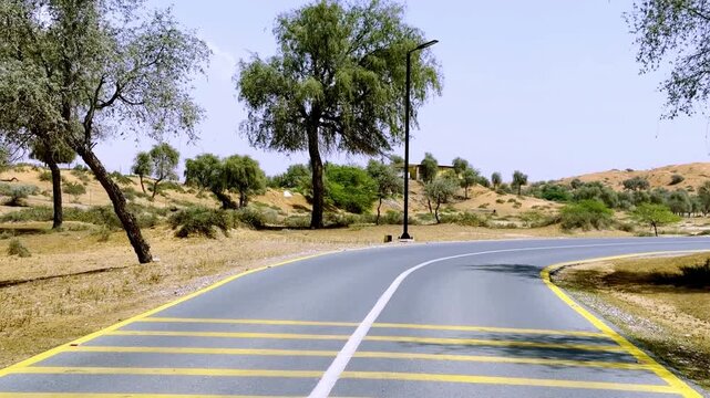 A stunning road view leading to The Ritz‑Carlton Ras Al Khaimah, framed by calm desert scenery and luxury ambience.