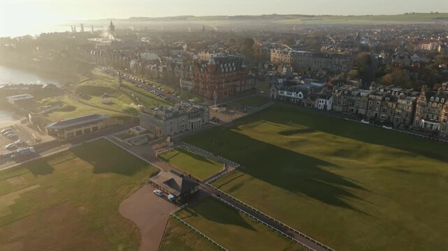 Aerial view of the expansive green fields and buildings of West Sands, bathed in the soft morning light, St Andrews, Scotland, United Kingdom.