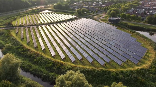 Solar panel island (Zoneiland) with reflections of sunlight on the solar panels. Aerial Shot in Almere, the Netherlands