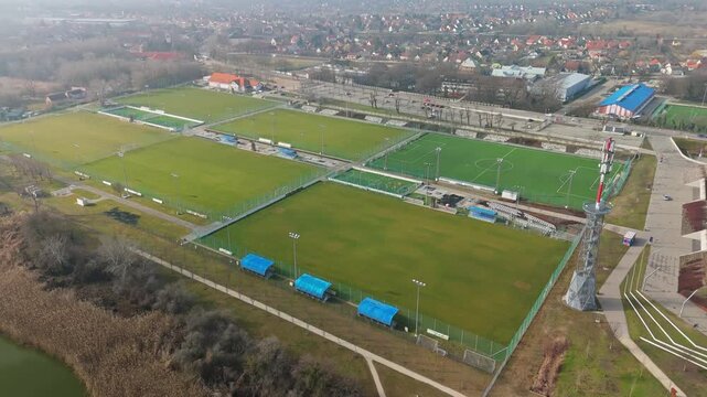 Sz&eacute;kesfeh&eacute;rv&aacute;r&rsquo;s S&oacute;st&oacute;i Stadion training area, home to Videoton FC, features a modern football field and athletic facilities with goalposts and bleachers, as seen from a drone's perspective.