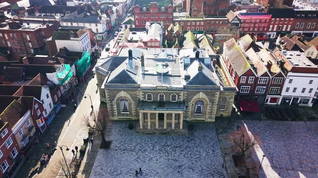 Drone aerial view of Salisbury Guildhall in Market Square surrounded by historic buildings and streets in Salisbury Wiltshire England UK