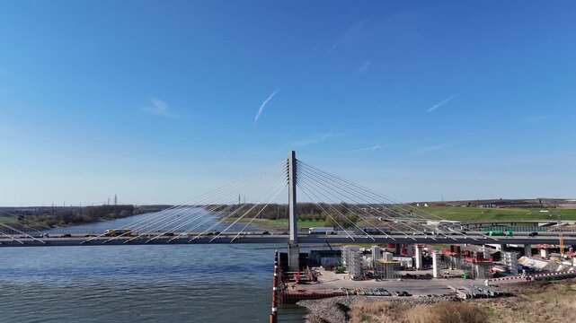 Drone moves over site showing complete bridge width and traffic