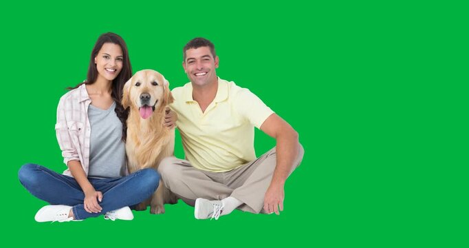 Portrait of caucasian couple with a dog smiling against black background