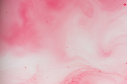 Soft pastel pink ink diffusion in water abstract background