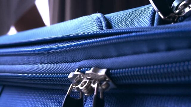Unrecognizable Woman Packing for Vacation Young woman makes the zipper a suitcase on the bed  LD Woman packing a suitcase for a vacation
