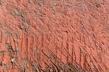 Fototapeta premium Red painted surface with scratches and rough texture