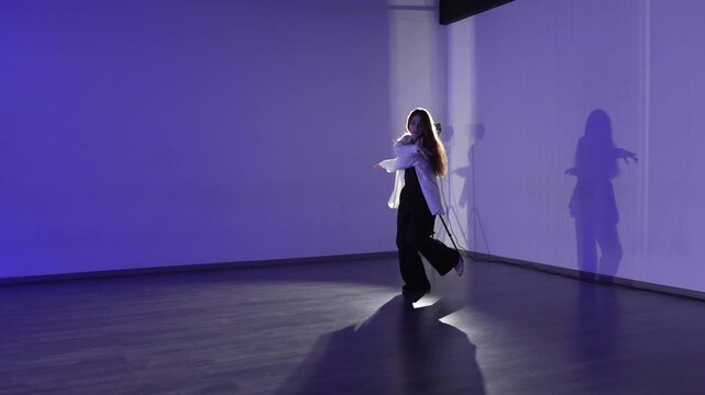 Dancer expression choreography young woman performing artistic modern dance in studio with blue light