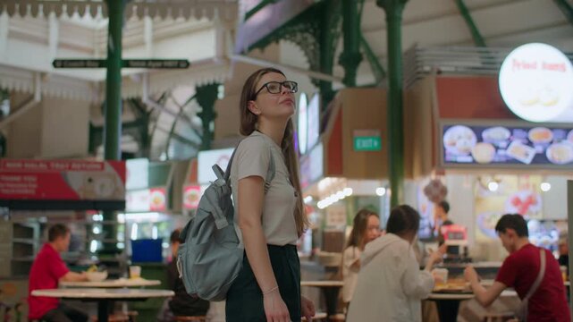 Woman tourist walking on Lau Pa Sat foot court in Singapore. Hawker center travel and tourism delicious Asian food.