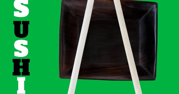 Sushi text with chopsticks over a black bowl on black surface