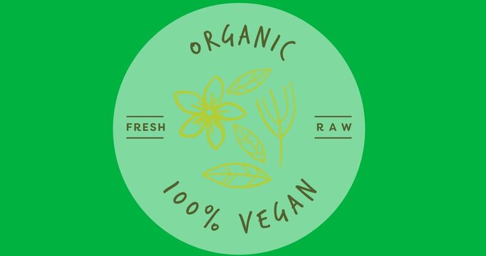Digital animation of organic 100 percent vegan text over a grey round banner on black background