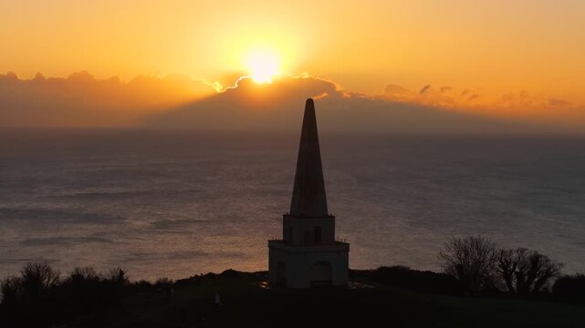 4K Cinematic drone footage, Silhouette of an obelisk at Killiney Hill during a stunning sunrise over the Dublin coastline. Perfect for travel and nature projects.08