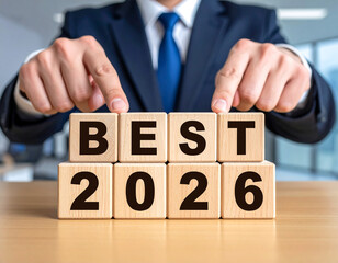 Naklejka premium Best 2026 - Geschäftsmann zeigt auf den Text 