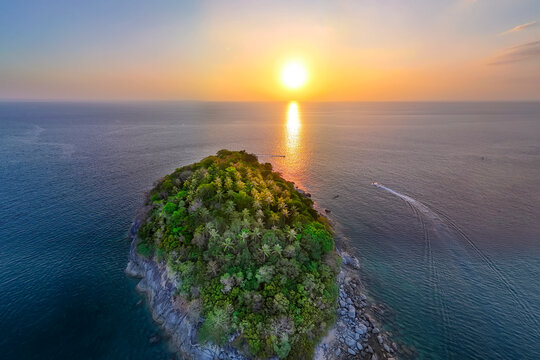 Golden light bathes the lush Ko Pu island and the tranquil Andaman Sea