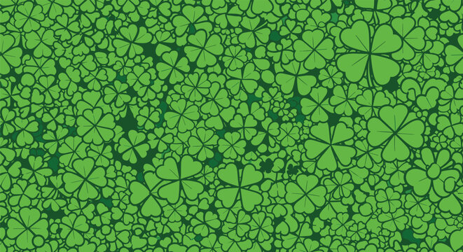 Dense seamless pattern of green four leaf clovers covering the entire frame for a lucky St Patricks Day themed background.
