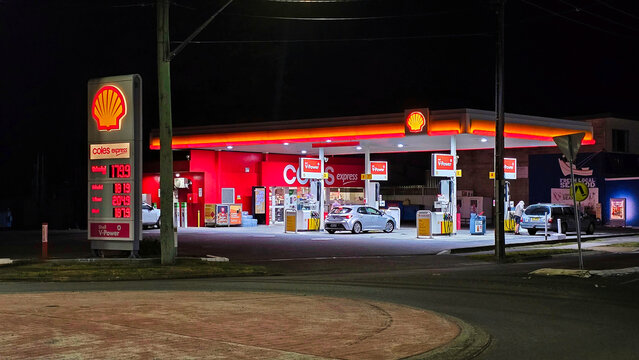 Gas station in Australia. Gasoline prices in 2024.Gas station at night with bright lights and cars nearby near Coles Express in a suburban area