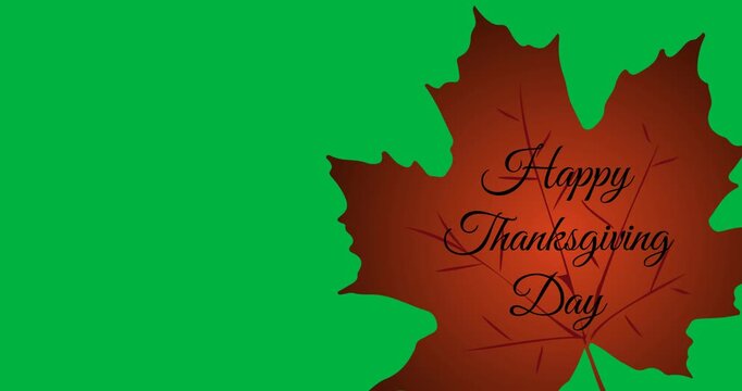 Digital animation of happy thanksgiving text on autumn maple leaf against black background
