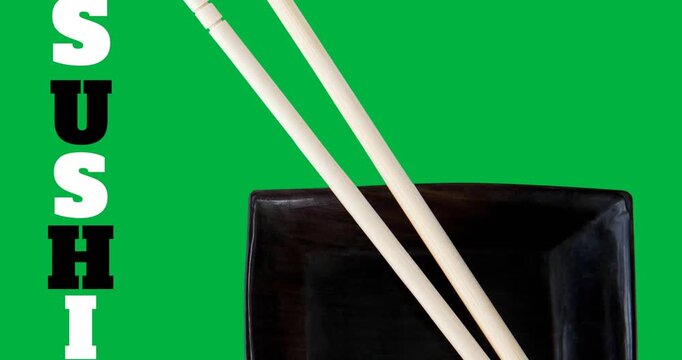 Sushi text with chopsticks over a black bowl on black surface