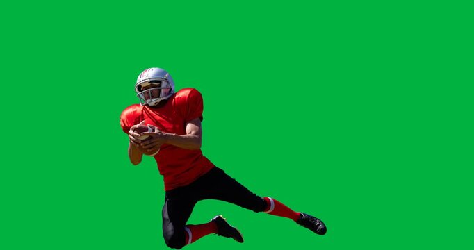 Male rugby player wearing helmet catching a rugby ball against black background