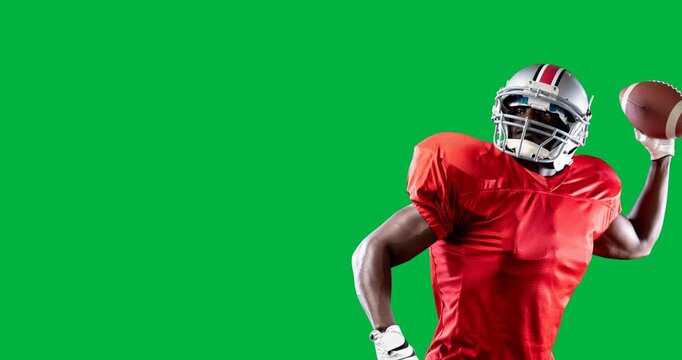 African american male rugby player throwing a helmet holding a rugby ball against black background