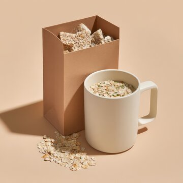 Healthy oats in a white mug alongside a carton.