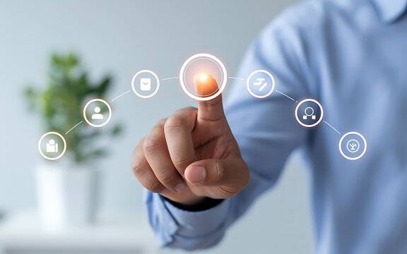 Man's finger touching glowing virtual interface with icons representing people and business services.