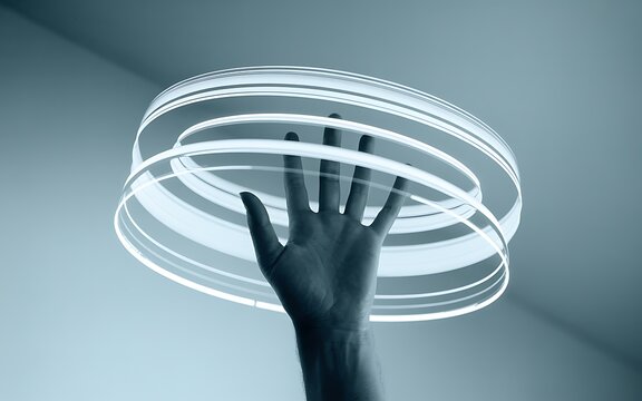 Hand with five fingers outstretched reaching through digital glowing concentric circles abstract technology interface.