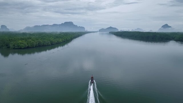 Drone shot tracking a boat on the sea, Phang nga bay, Thailand