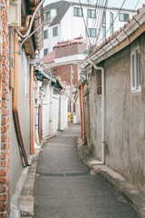 Fototapeta premium Narrow curved alley between old residential buildings