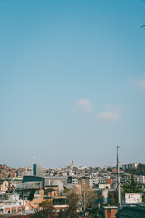 Obraz premium Urban skyline with church and residential buildings under blue sky