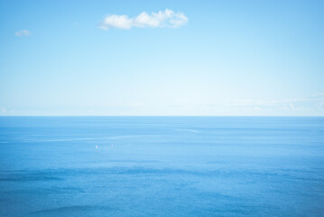 Fototapeta premium Tyrrhenian Sea, Italy: Two sailboats on a calm blue ocean under a clear sky