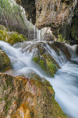 Fototapeta premium Smooth Silk Waterfall in Green Wilderness – Serenity and Nature Background