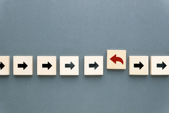 One arrow turns in the opposite direction, representing change, contrarian thinking, and strategic pivot in business or decision making