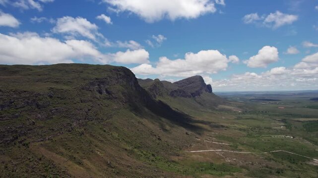 Stunning Mountain Range Under Blue Sky with Clouds on Sunny Day