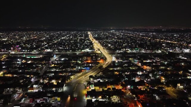 Night aerial of urban housing and avenues in Ecatepec