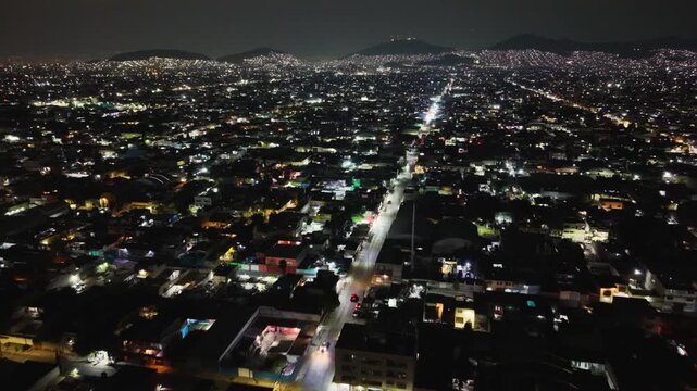 Nighttime aerial of houses and avenues in Ecatepec cityscape