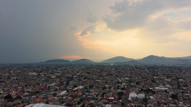 Drone view of CDMX and Ecatepec under warm sunset tones