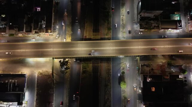 Aerial view of road interchange with cars at night