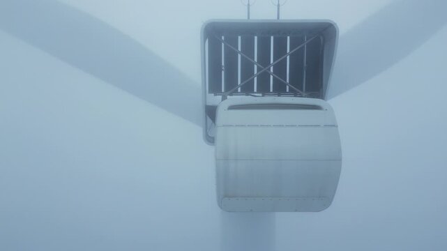 Rear View of Wind Turbine Nacelle with Open Hatch in Thick Fog