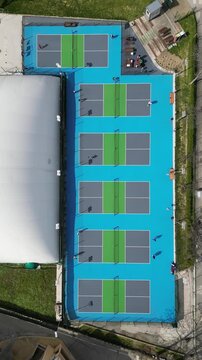 Timelapse Aerial View of Pickleball Games on Outdoor Blue Courts