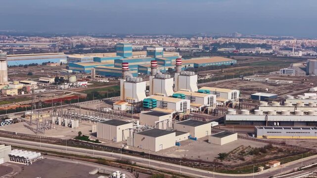 Combined cycle gas power plant with turbines, heat recovery steam generators, exhaust stacks and high-voltage switchyard delivering electricity to the transmission grid