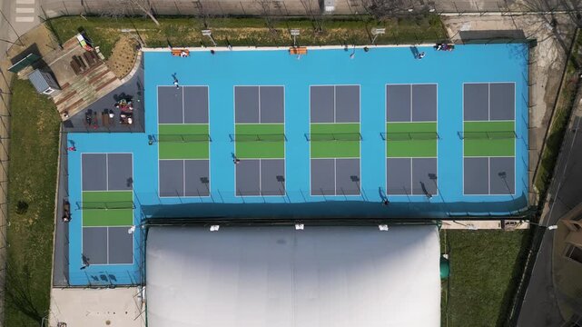 Top Down Aerial View of People Playing Pickleball on Blue Courts