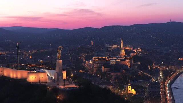 Renovated Liberty Statue, Szabads&aacute;g Szobor, Citadella visitor center and Hungarian flag on Gell&eacute;rt Hill in Budapest, Hungary.
